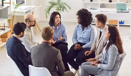 Line manager training A group of people talking in a circle